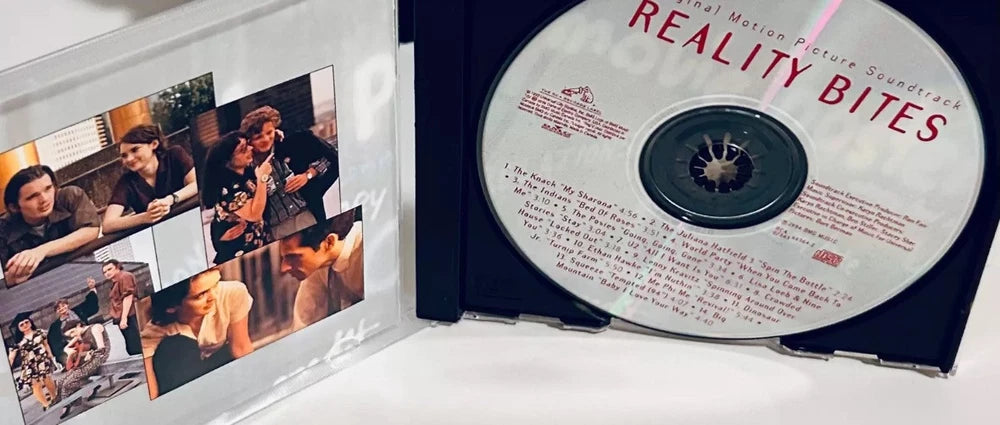 A "Reality Bites" movie soundtrack CD, showcasing cast members on the sleeve.