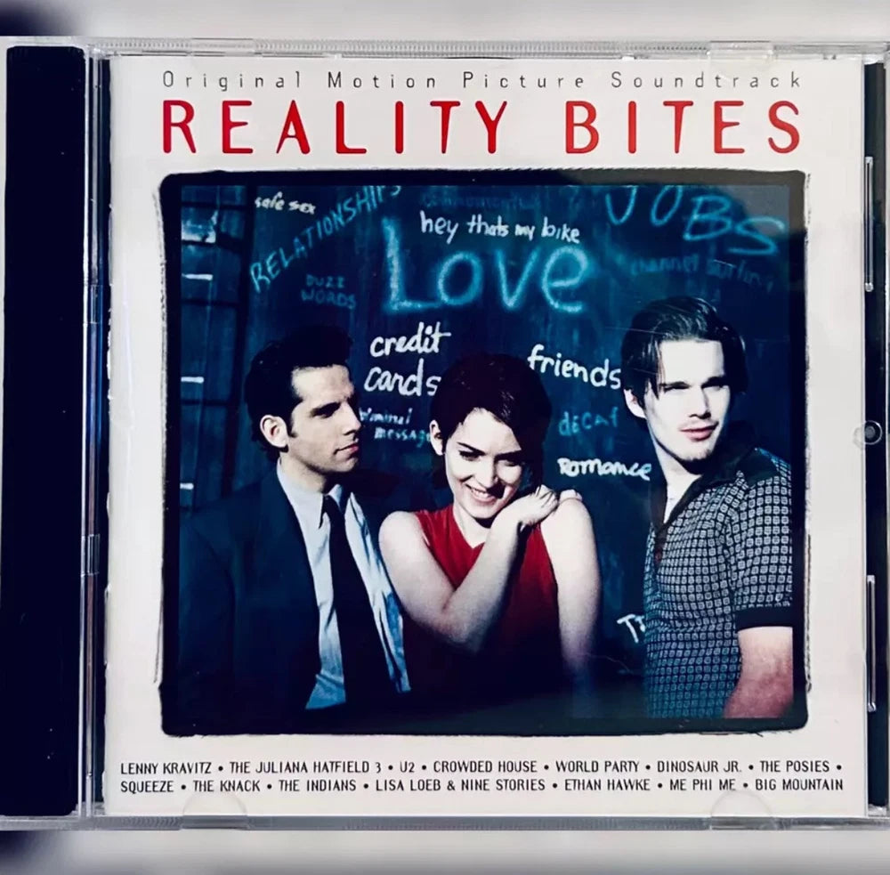 CD case cover featuring the "Reality Bites" movie soundtrack. The cover art depicts three actors in front of a chalkboard with words such as "Love," "Jobs," and "Relationships" written on it.