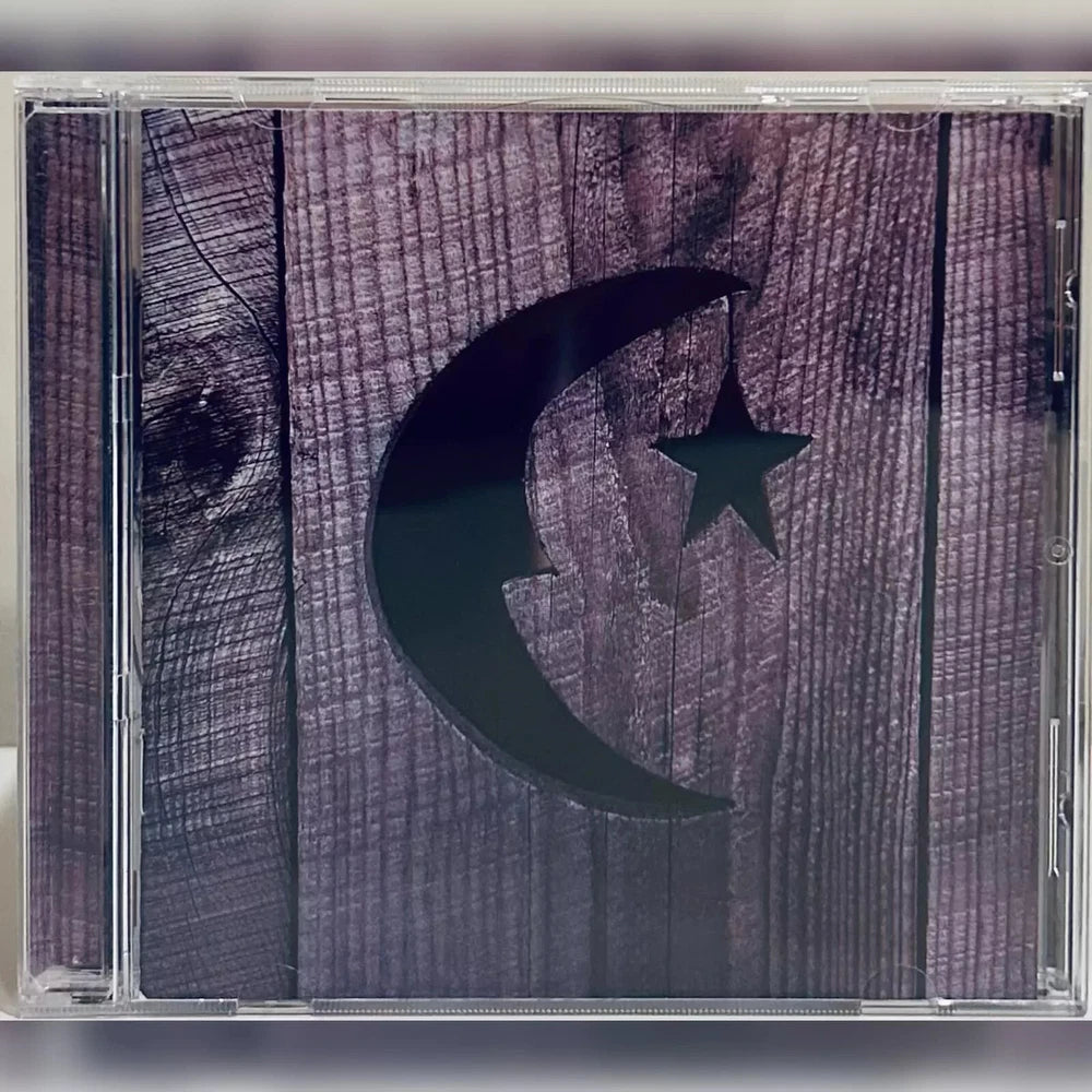 A CD case with a wooden plank design background featuring a black crescent moon and star.